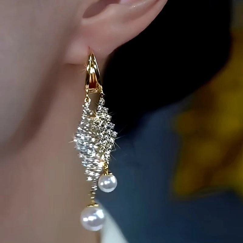 Model showcasing the dangle and style of the 14K Gold Plated Diamond Pearl Tassel Earrings