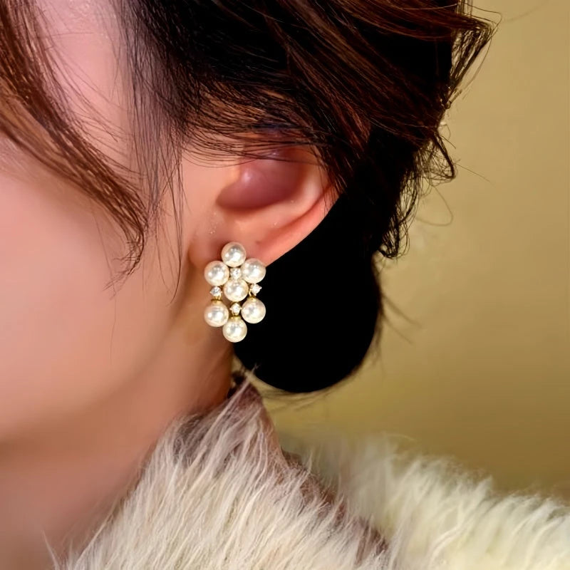 Model showcasing the dangle and style of the 14K Gold-Plated Diamond Pearl Tassel Earrings
