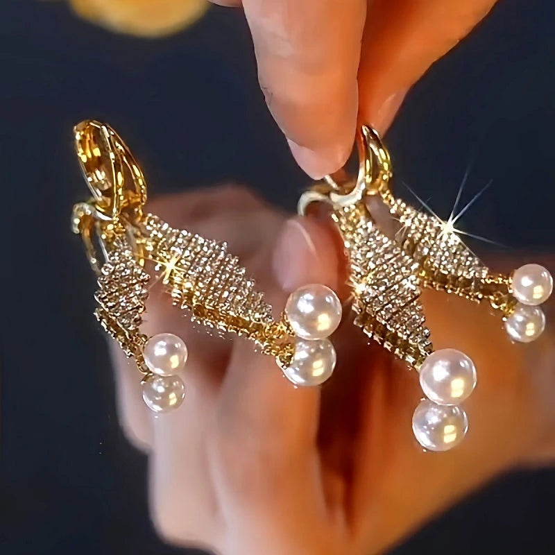 Close-up detail of the sparkling zircons and plating on the gold pearl earrings