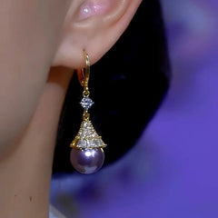 Model showcasing the dangle and style of the 14K Gold-Plated Diamond Purple Pearl Earrings