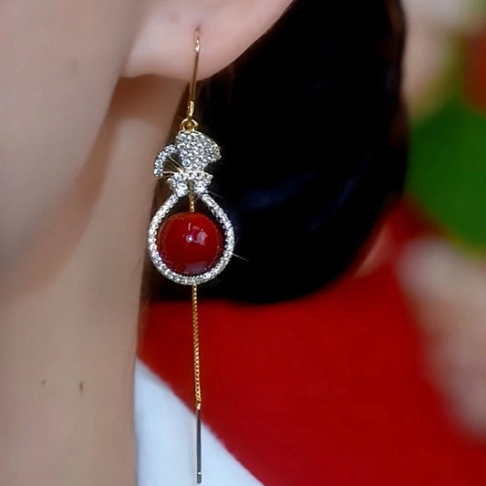 Model showcasing the dangle and style of the 14K Gold-Plated Diamond Purse Pearl Earrings