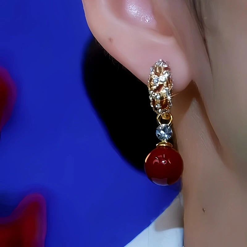 Close-up detail of the sparkling zircons and plating on the Red Pearl Earrings