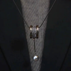 Close-up of the pendant and clasp on the Long Pearl Necklace