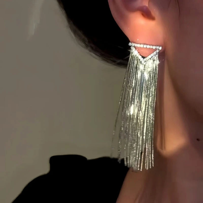 Model showcasing the dangle and style of the 14K Gold-Plated Diamond Tassel Earrings