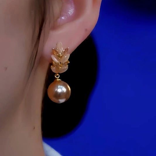 Model showcasing the dangle and style of the 14K Gold-Plated Diamond Wheat Pearl Earrings