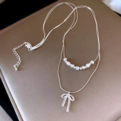 14K Gold-Plated Double-Layer Bead Bow Necklace worn to showcase its length and pendant detail