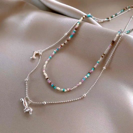 14K Gold-Plated Double-Layer Bead Puppy Necklace worn to showcase its length and pendant detail