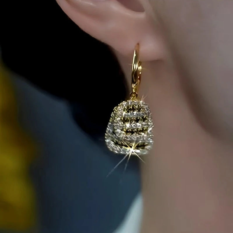 Model showcasing the dangle and style of the 14K Gold-Plated Double-Layer Black And White Diamond Earrings