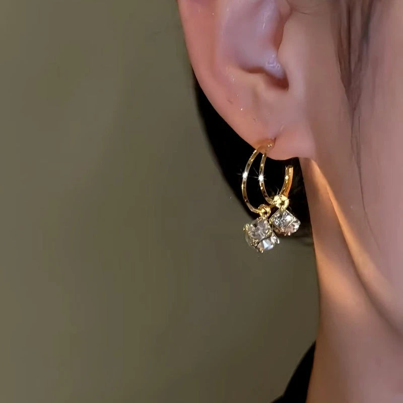 Model showcasing the dangle and style of the 14K Gold-Plated Double-Layer Daimond Tassel Earrings