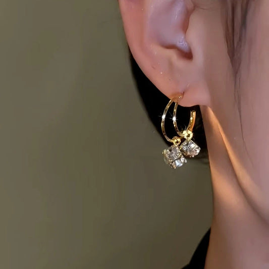 Model showcasing the dangle and style of the 14K Gold-Plated Double-Layer Daimond Tassel Earrings