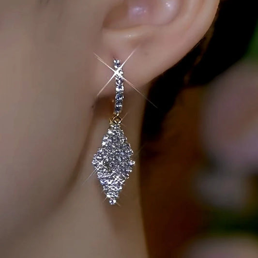 Model showcasing the dangle and style of the 14K Gold-Plated Double-Layer Diamond Earrings