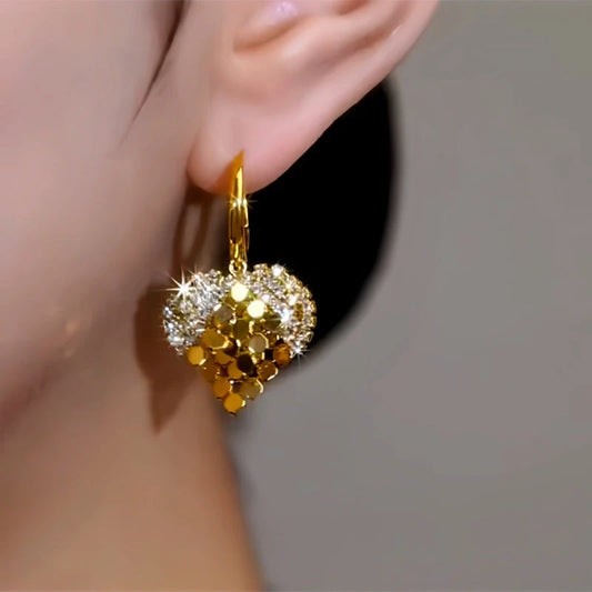 Model showcasing the dangle and style of the 14K Gold-Plated Double-Layer Diamond Sequin Heart Earrings