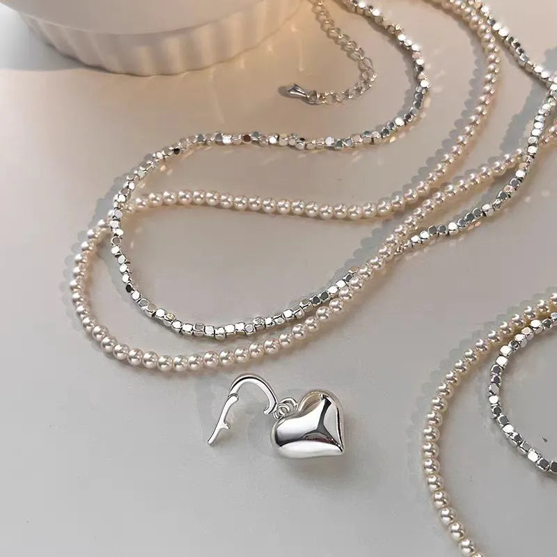 Detailed view of the 14K Gold-Plated Double-Layer Silver Heart Pendant Necklace chain and pendant