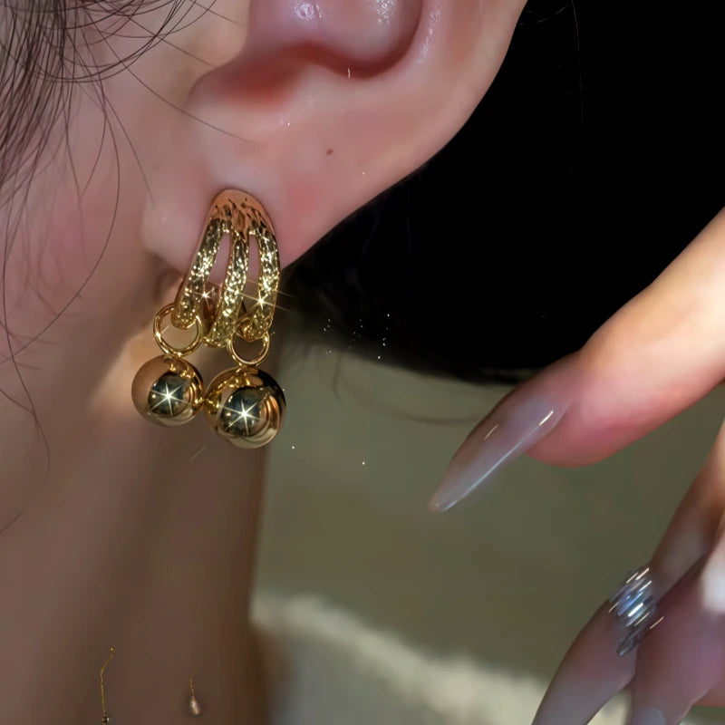 Model showcasing the dangle and style of the 14K Gold-Plated Double-Layer Water Drop Earrings