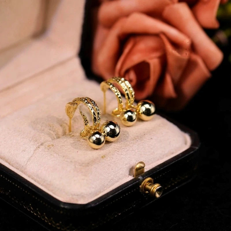 Angled view of the 14K Gold-Plated Double-Layer Water Drop Earrings