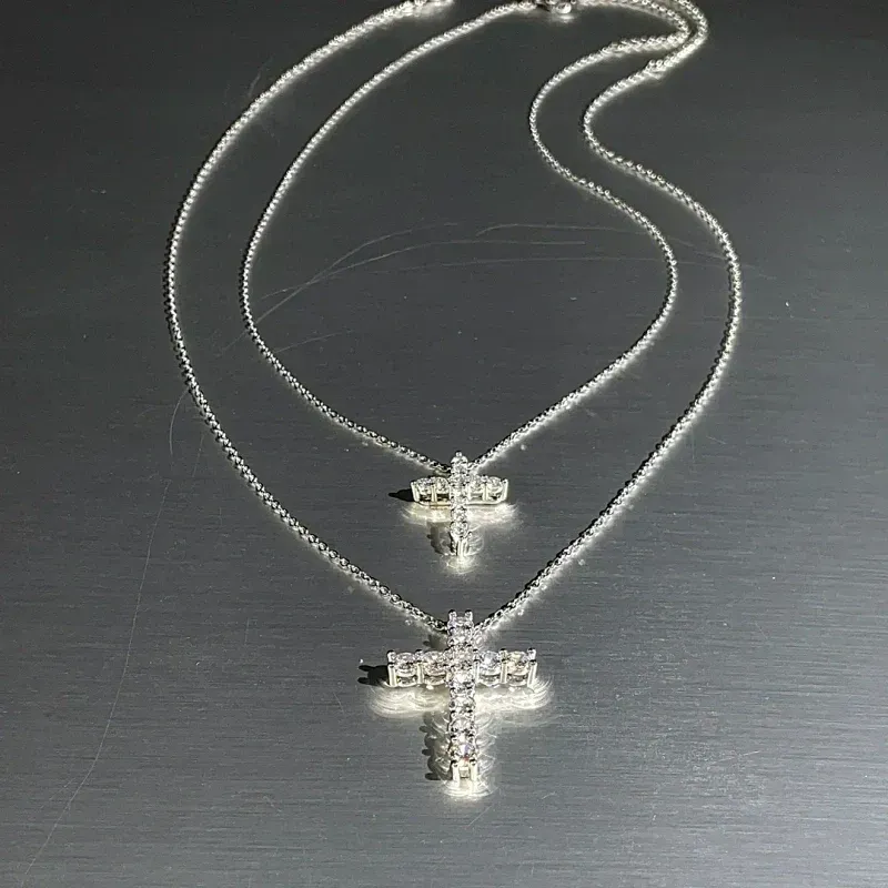 Close-up of the pendant and clasp on the Cross Necklace