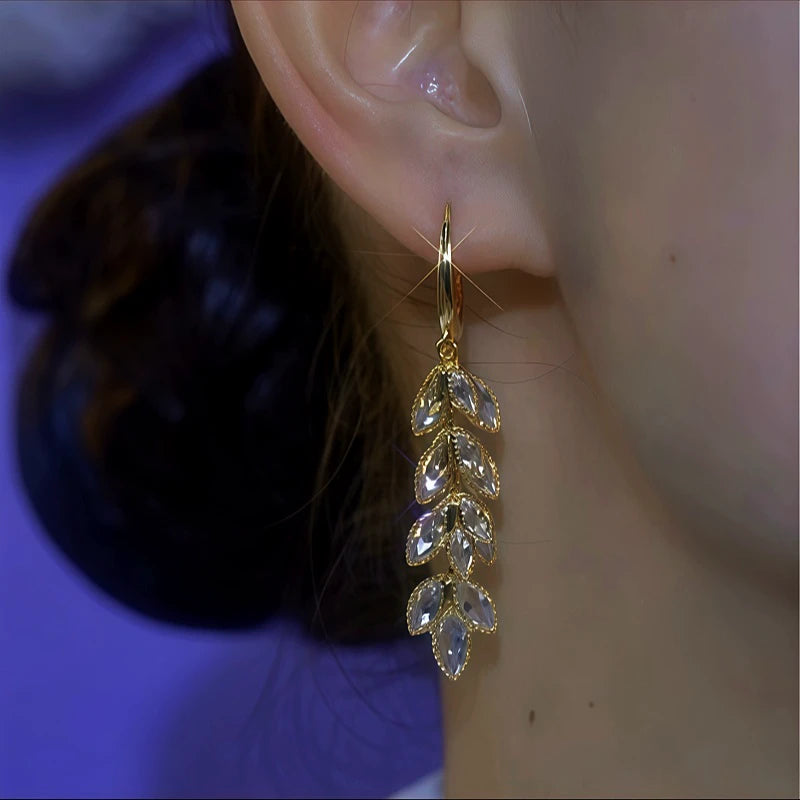 Model showcasing the dangle and style of the 14K Gold-Plated Double-Layer Zircon Wheat Tassel Earrings
