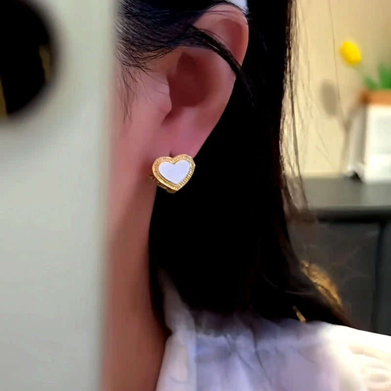Close-up detail of the sparkling zircons and plating on the Double-Sided Heart Earrings