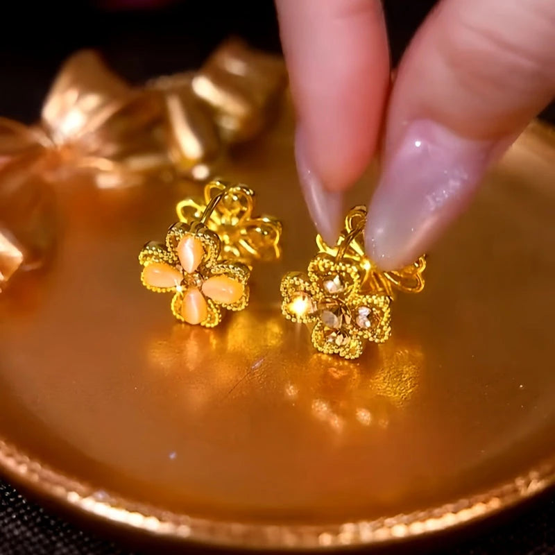 Model showcasing the dangle and style of the 14K Gold-Plated Double-Sided Cat's Eye Flower Earrings