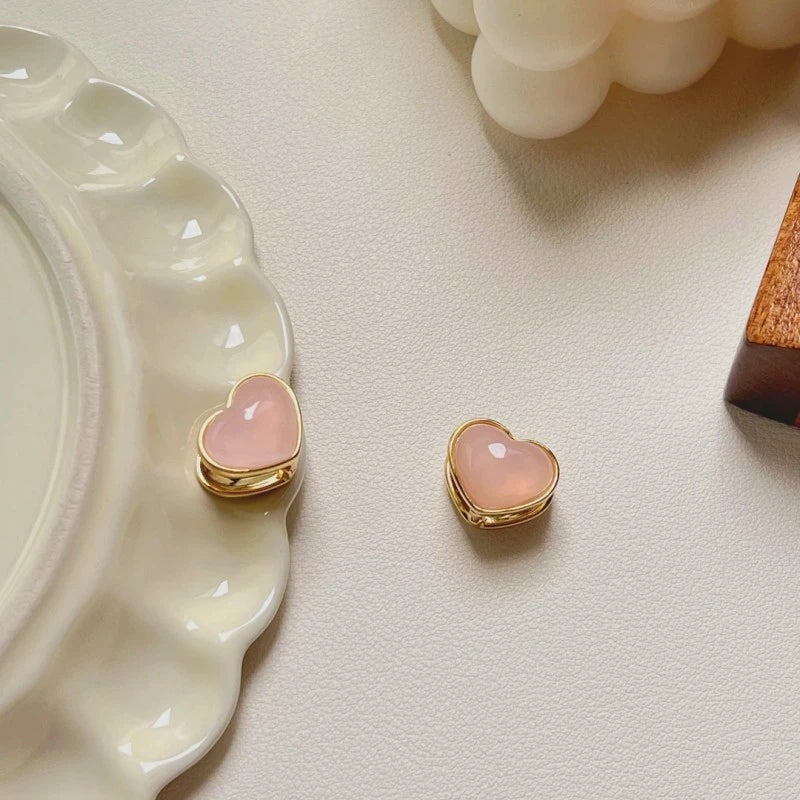 Close-up detail of the sparkling zircons and plating on the Double-Sided Heart Earrings