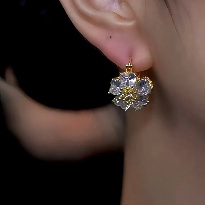 Model showcasing the dangle and style of the 14K Gold-Plated Double-Sided Zircon Flower Earrings