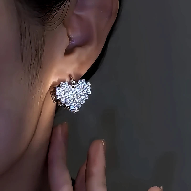 Model showcasing the dangle and style of the 14K Gold-Plated Double-Sided Zircon Heart Earrings