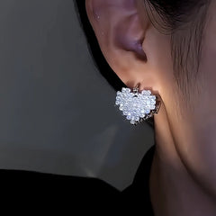 Close-up detail of the sparkling zircons and plating on the Double-Sided Heart Earrings