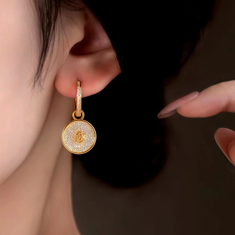 Model showcasing the dangle and style of the 14K Gold-Plated Double-Sided Zircon Pearl Earrings