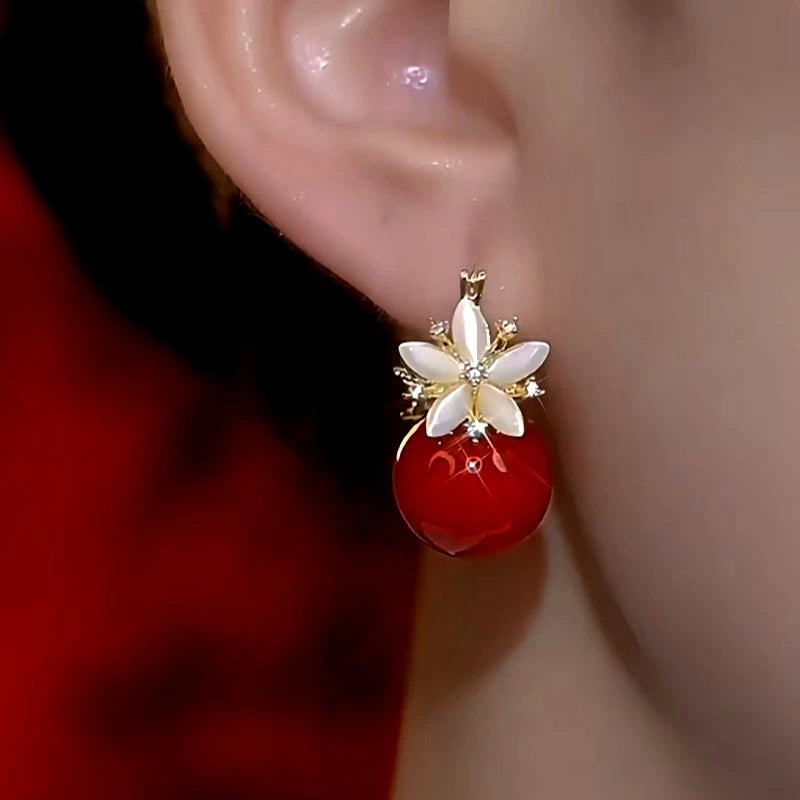 Model showcasing the dangle and style of the 14K Gold-Plated Double-Sided Zircon Pearl Flower Earrings