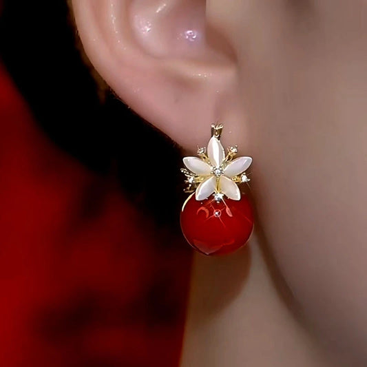 Model showcasing the dangle and style of the 14K Gold-Plated Double-Sided Zircon Pearl Flower Earrings