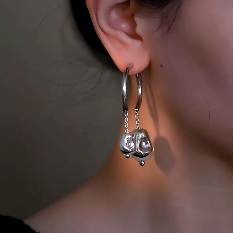 Model showcasing the dangle and style of the 14K Gold-Plated Double Ball Asymmetrical Earrings