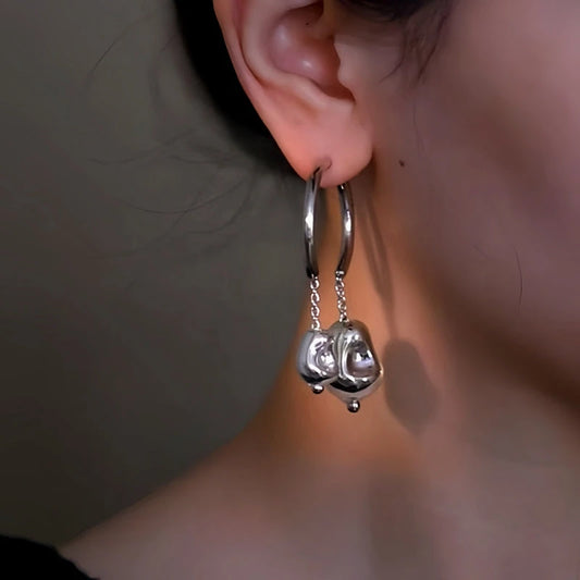 Model showcasing the dangle and style of the 14K Gold-Plated Double Ball Asymmetrical Earrings