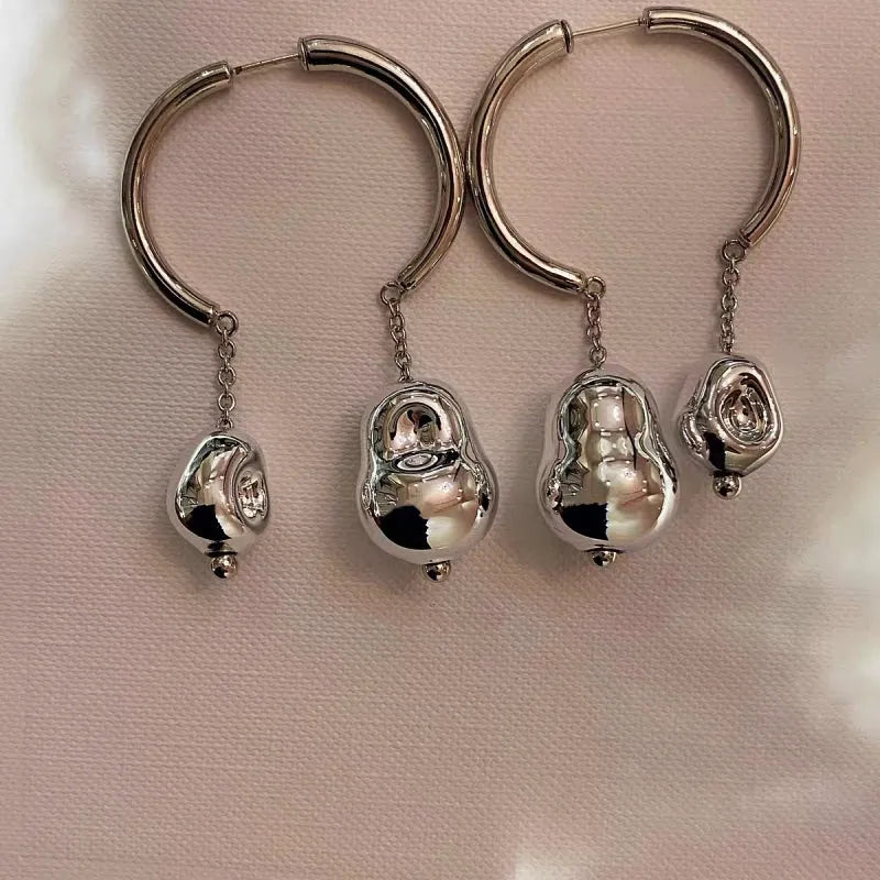 Close-up detail of the sparkling zircons and plating on the Asymmetrical Earrings