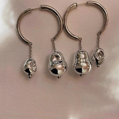 Close-up detail of the sparkling zircons and plating on the Asymmetrical Earrings