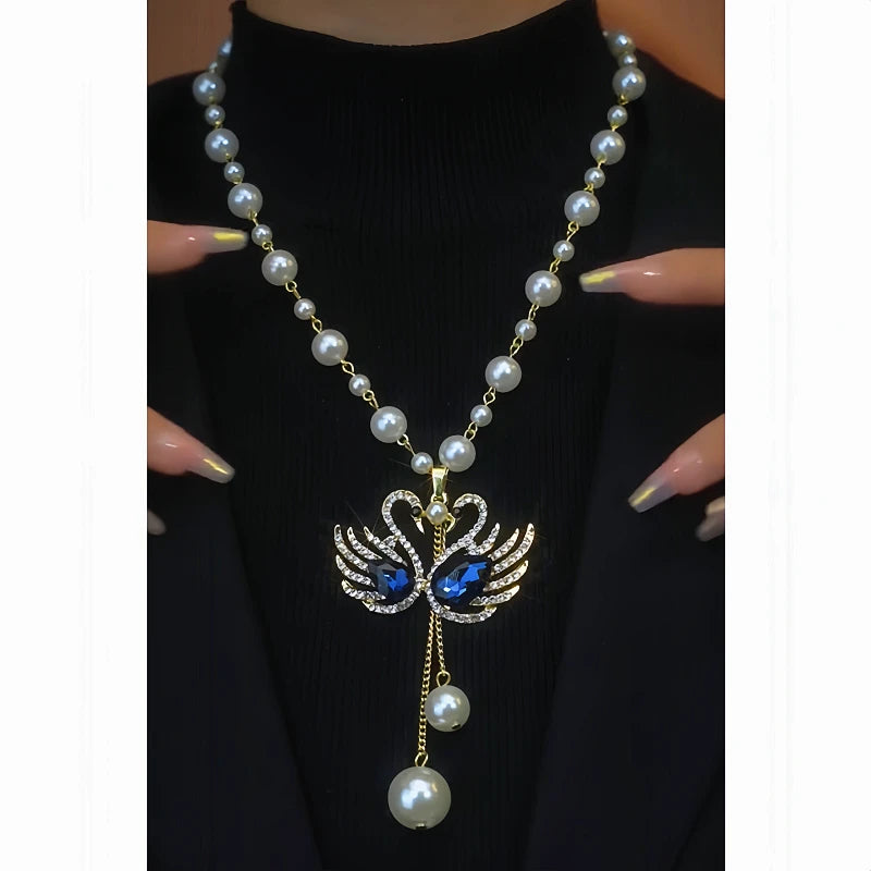 Close-up of the pendant and clasp on the Goose Pearl Necklace