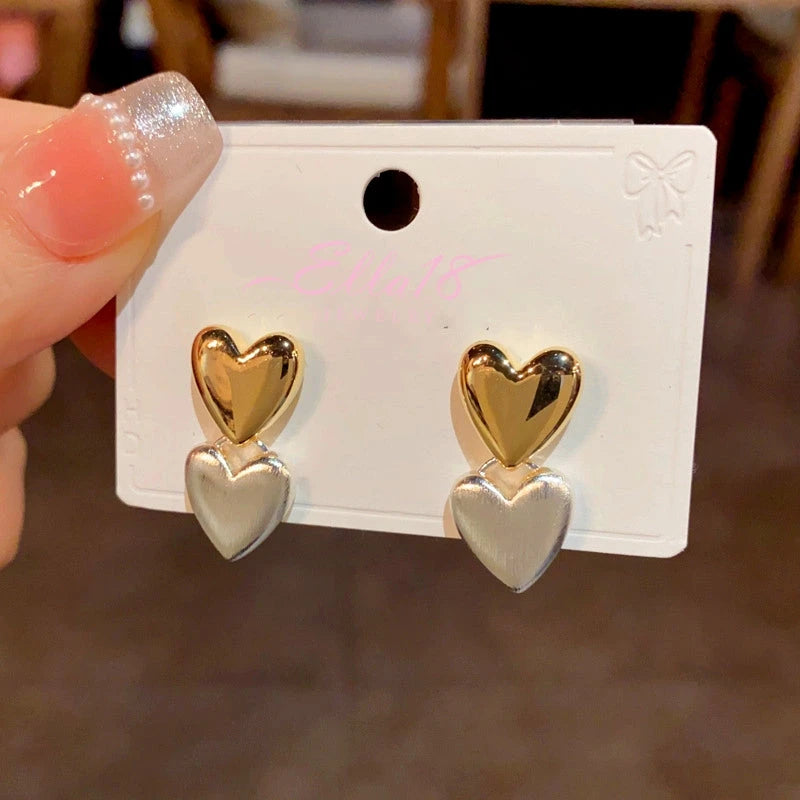 Angled view of the 14K Gold-Plated Double Heart Earrings