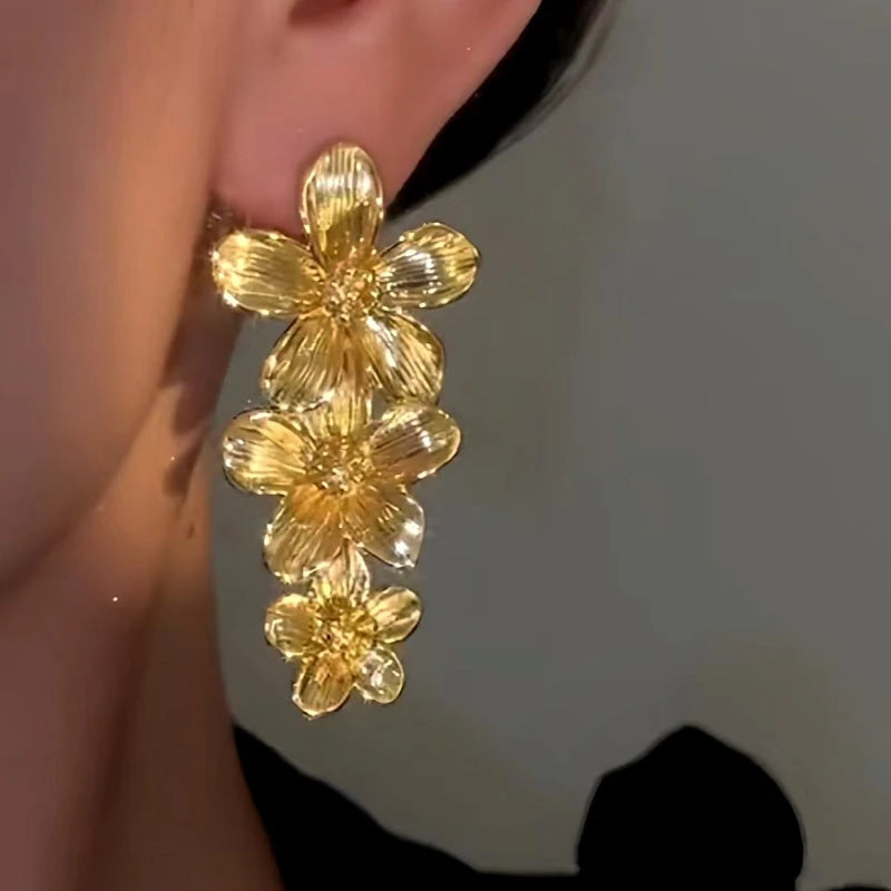 Model showcasing the dangle and style of the 14K Gold-Plated Elegan Flower Tassel Earrings