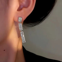 Model showcasing the dangle and style of the 14K Gold-Plated Elegan Zircon Tassel Earrings