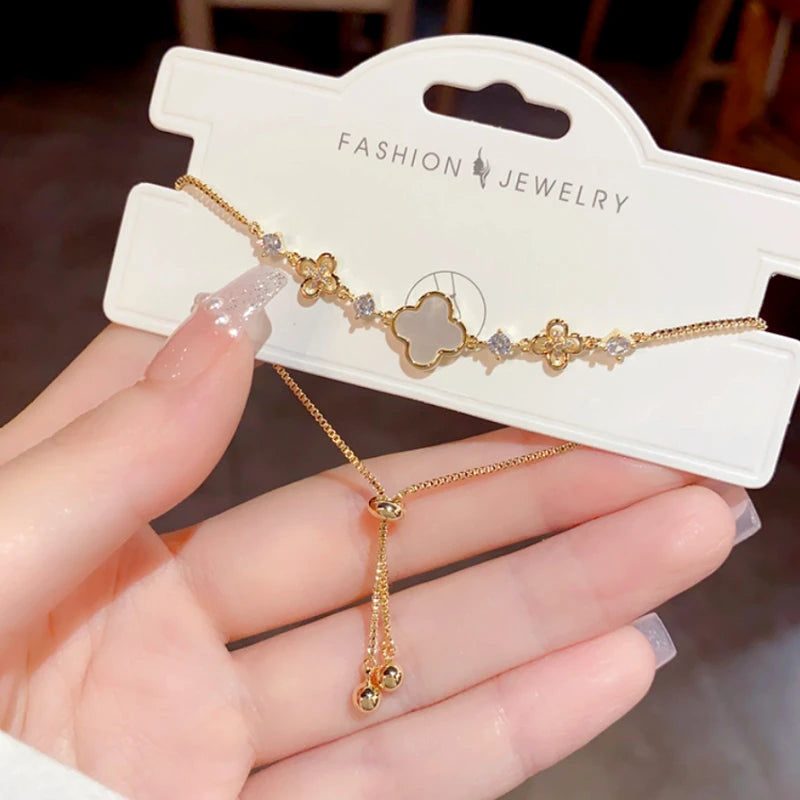 Model wearing the 14K Gold-Plated Elegant Adjustable Zircon Four-Leaf Bracelet to highlight its design on the wrist