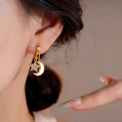 Model showcasing the dangle and style of the 14K Gold-Plated Elegant And Exquisite Zircon Star And Oil Drop Moon Tassel Earrings