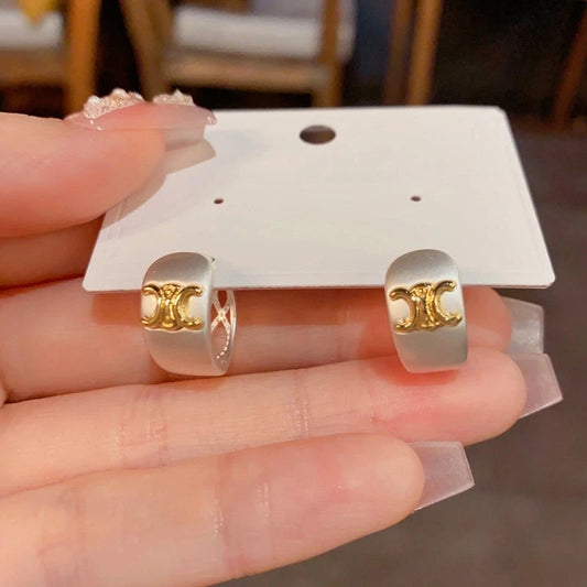 Model showcasing the dangle and style of the 14K Gold-Plated Elegant Arc De Triomphe Earrings