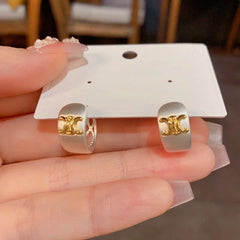 Model showcasing the dangle and style of the 14K Gold-Plated Elegant Arc De Triomphe Earrings