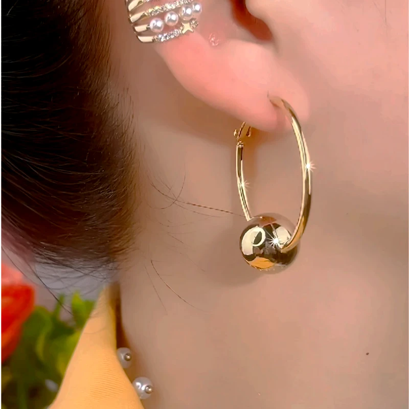 Close-up detail of the sparkling zircons and plating on the Ball Hoop Earrings