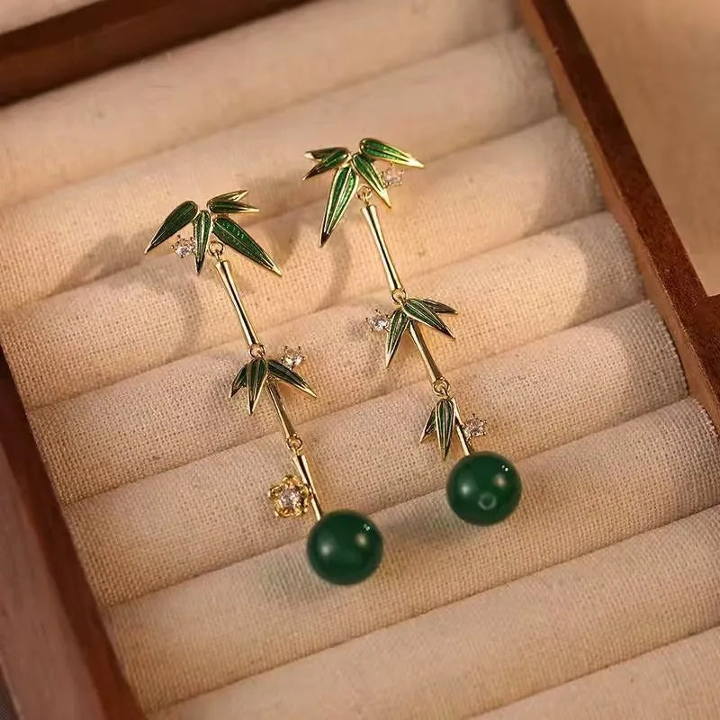 Model showcasing the dangle and style of the 14K Gold-Plated Elegant Bamboo Earrings