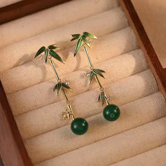 Model showcasing the dangle and style of the 14K Gold-Plated Elegant Bamboo Earrings