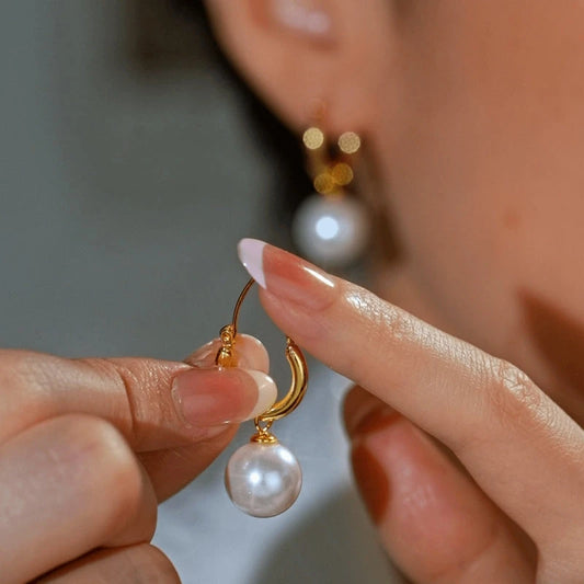Model showcasing the dangle and style of the 14K Gold-Plated Elegant Beaded Earrings
