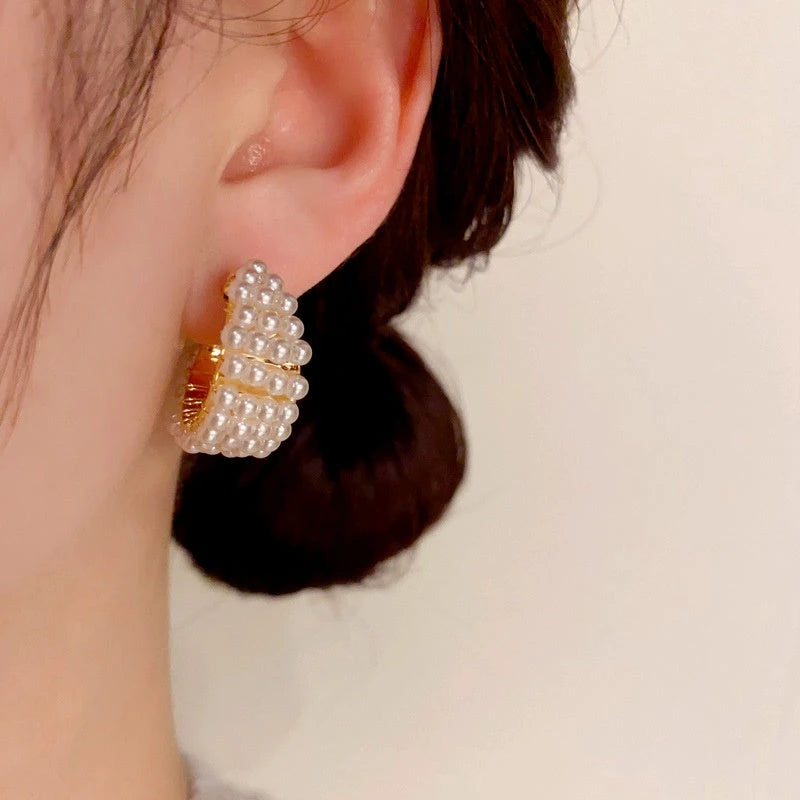 Model showcasing the dangle and style of the 14K Gold-Plated Elegant Beaded Earrings