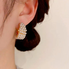 Model showcasing the dangle and style of the 14K Gold-Plated Elegant Beaded Earrings