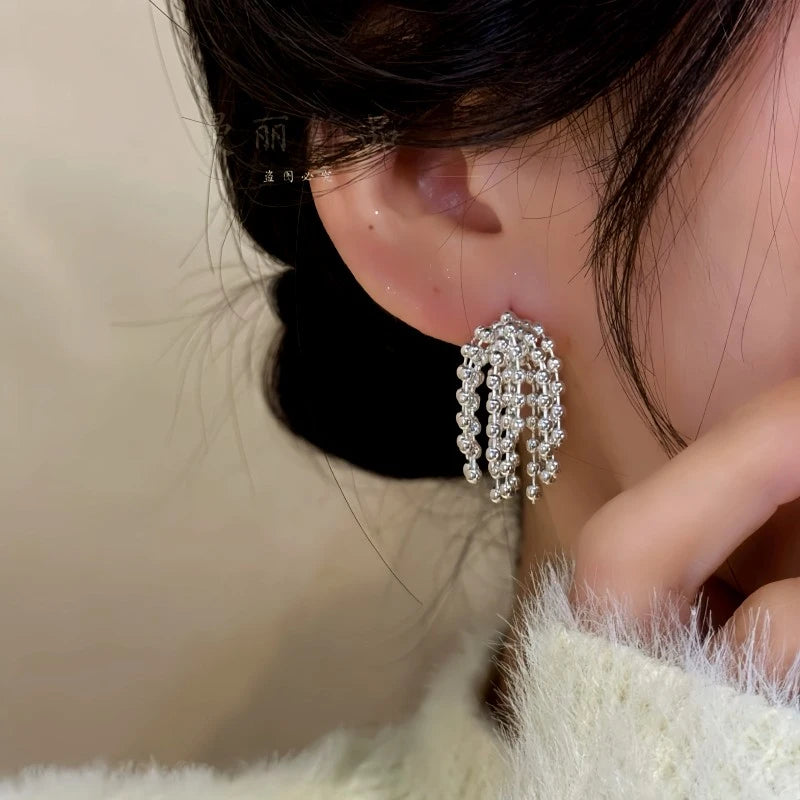 Angled view of the 14K Gold-Plated Elegant Beaded Tassel Earrings