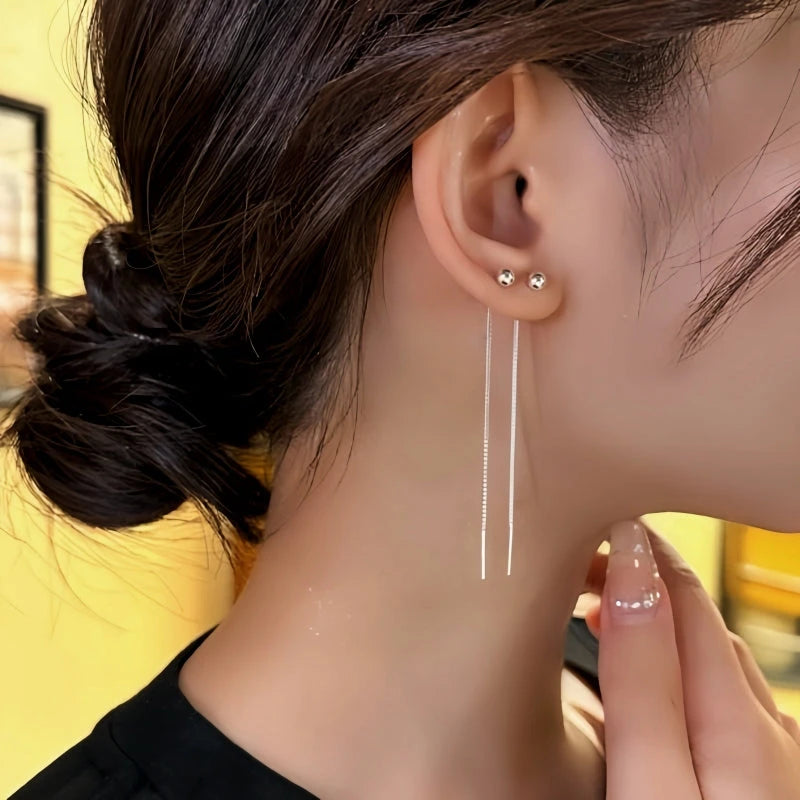 Model showcasing the dangle and style of the 14K Gold-Plated Elegant Bean Threader Earrings